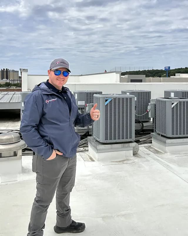 Ben Randall beside commercial HVAC equipment